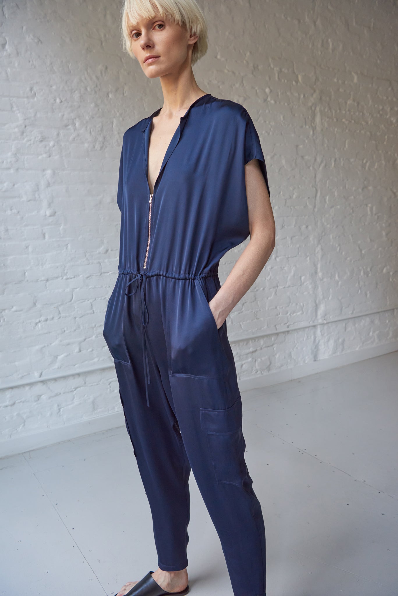Women's v-neck zip front navy satin jumpsuit with pockets