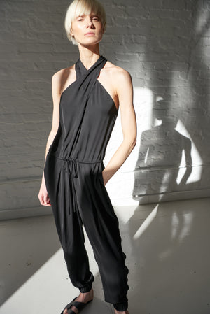 Model wearing black halter neck jumpsuit with pockets