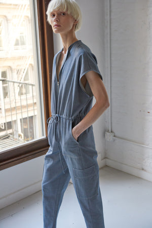 Model wearing women's organic cotton denim jumpsuit