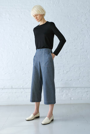 woman wearing long sleeve top made with an airy delicate interlock jersey in black and denim culottes