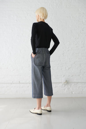 woman wearing denim culottes cropped pant made with organic cotton yarn in dark indigo back view