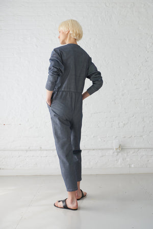 woman wearing japanese denim jumpsuit with sleeves made from GOTS organic cotton in indigo blue back view