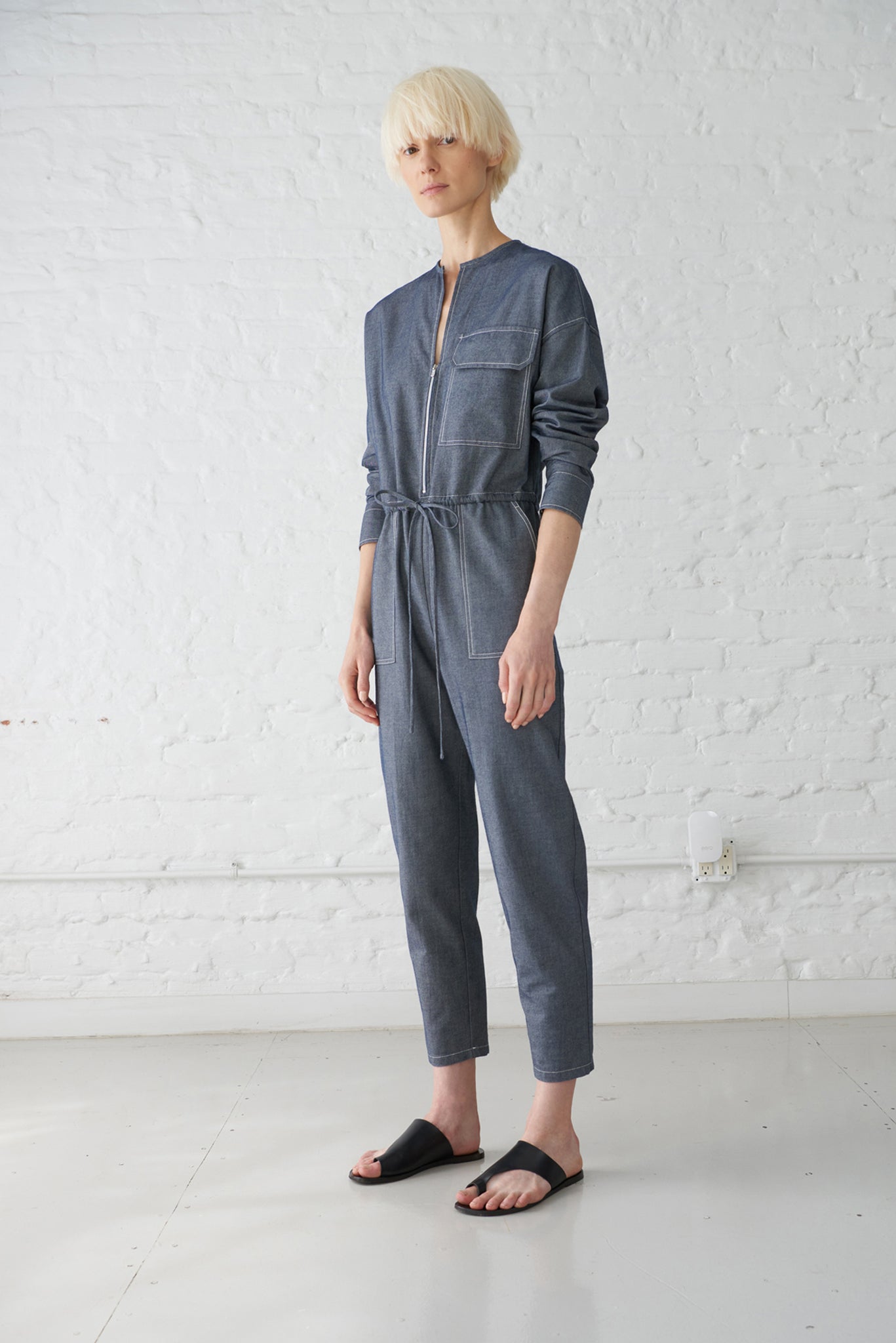 woman wearing japanese denim jumpsuit with sleeves made from GOTS organic cotton in indigo blue
