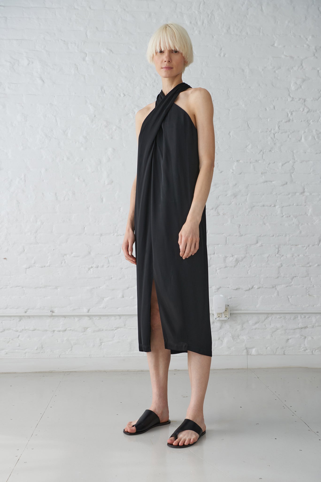 woman wearing black halter neck dress made from sustainable viscose satin