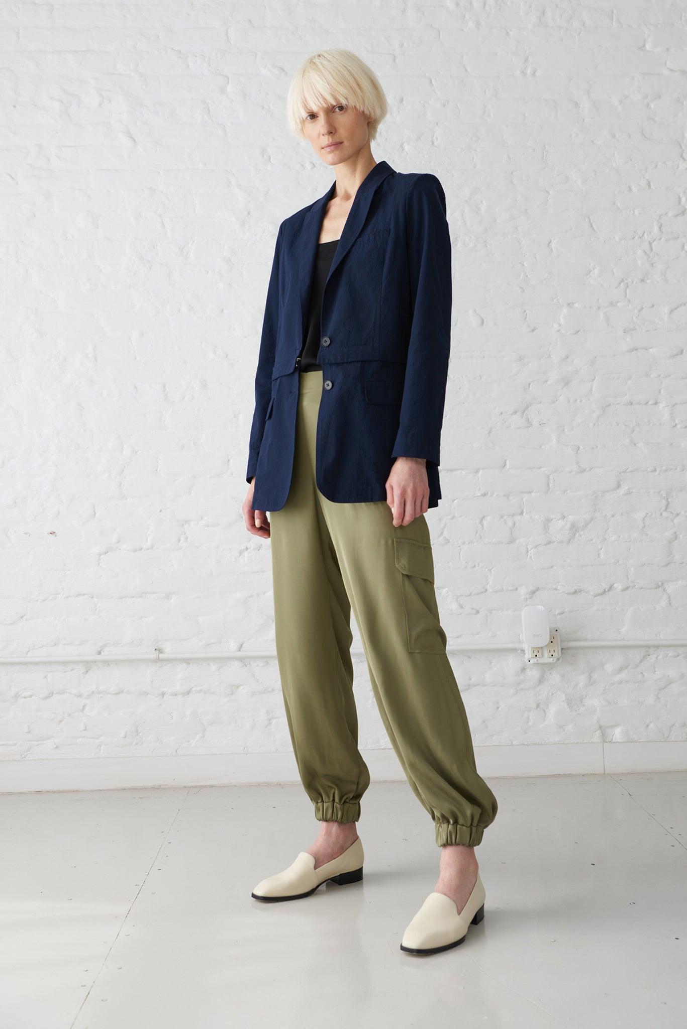 woman wearing 2-in-1 convertible blazer jacket made from GOTS organic cotton in navy blue